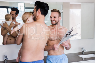 Smiling gay couple with child