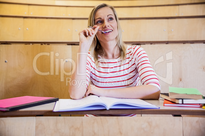 Smiling female student thinking