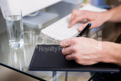 Cropped image of man using graphic tablet