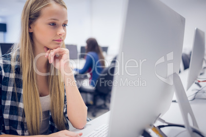 Serious student working on computer