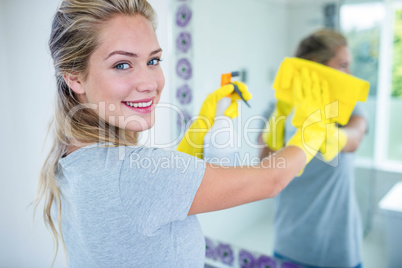 Woman cleaning the mirror