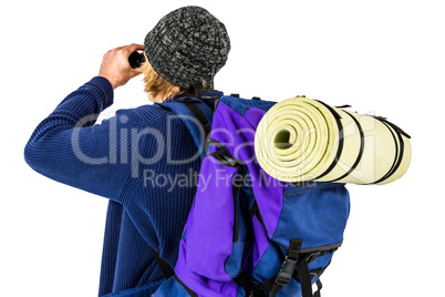 Backpacker looking through his binoculars