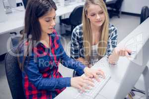 Serious student working on computer