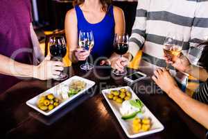 Friends having an aperitif with wine