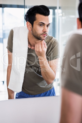 Handsome man looking in mirror