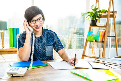 Focused hipster businessman writing