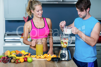 Healthy couple preparing a smoothie