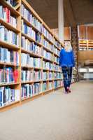 Female student walking in the library