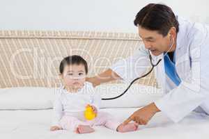 Doctor visiting cute baby