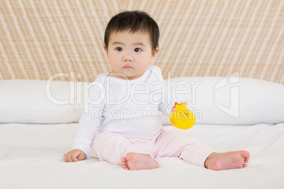 Cute baby holding plastic duck