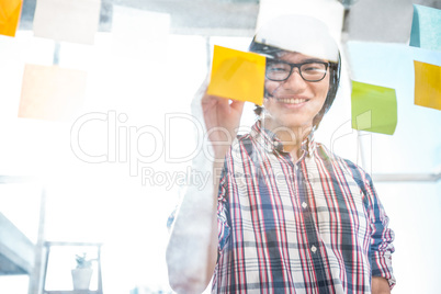 Creative businessman writing on sticky notes