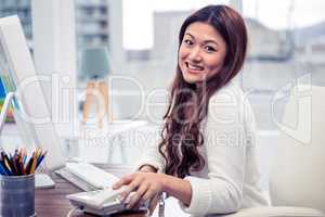 Smiling Asian woman holding phone