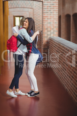 Happy students hugging after receiving results