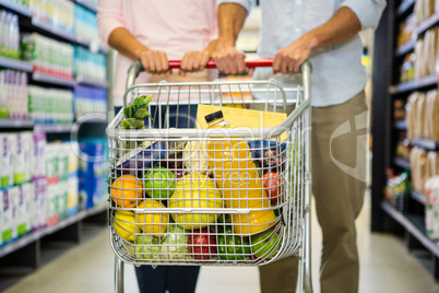 Couple pushing cart together