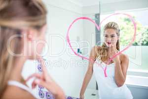 Woman with lipstick looking in the mirror
