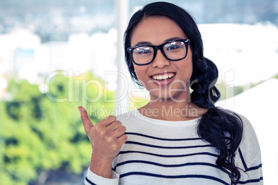 Smiling Asian woman showing thumb up Smiling Asian woman showing thumb up