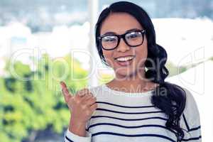 Smiling Asian woman showing thumb up