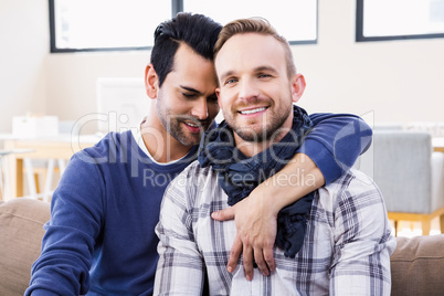 Gay couple hugging on the couch