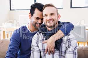 Gay couple hugging on the couch