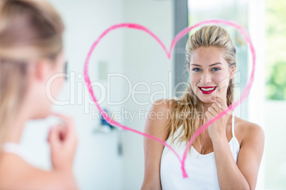 Woman with lipstick looking in the mirror