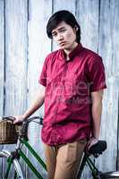 Hipster man holding a bike