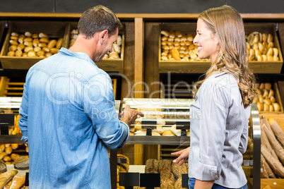 Happy couple looking at bread