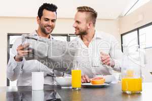 Smiling gay couple reading newspaper