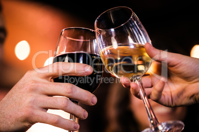 Close up of friends toasting with wine