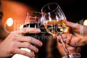 Close up of friends toasting with wine
