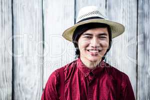 Smiling hipster with a straw hat