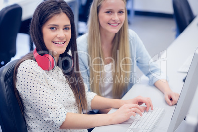 Smiling students using computer