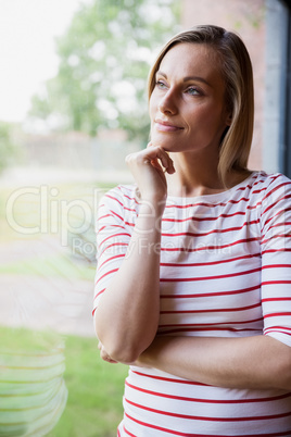 Thoughtful female student looking through the window