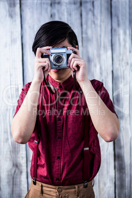 Hipster taking pictures with an old camera