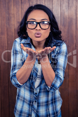Asian woman blowing kiss to the camera