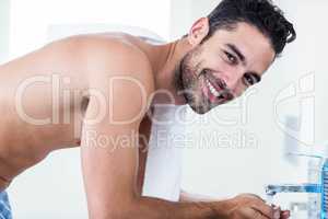 Man washing his face in sink