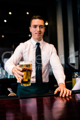 Barman serving a pint of beer