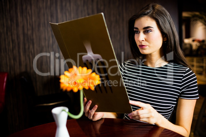 Attractive woman reading the menu