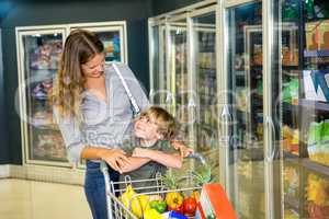 Mother and son doing grocery shopping