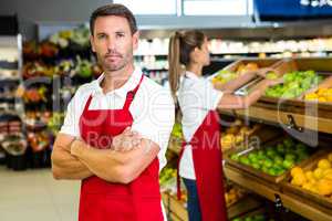 Smiling worker in front of colleague