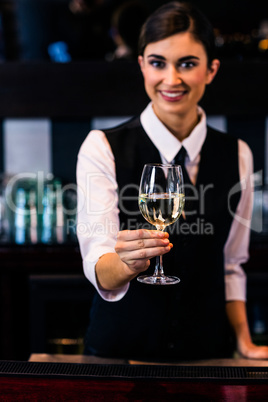 Barmaid serving a glass of wine