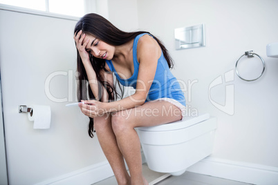 Anxious brunette waiting pregnancy test result