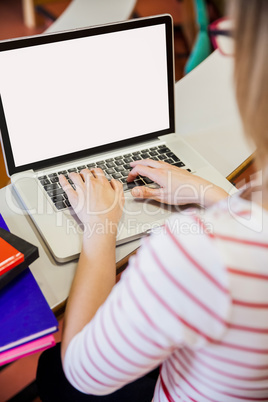 Female student typing on laptop