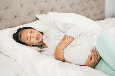 Pregnant brunette sleeping