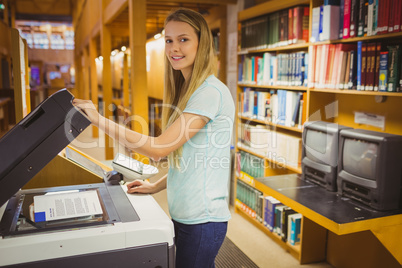 Smiling blonde student making a copy