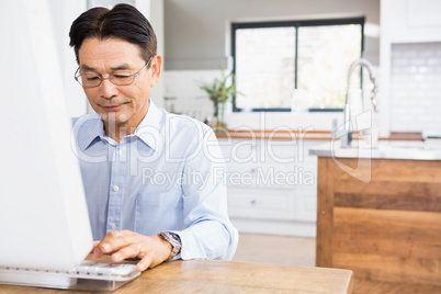 Smiling man using computer