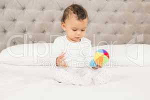Cute baby playing with colorful toy