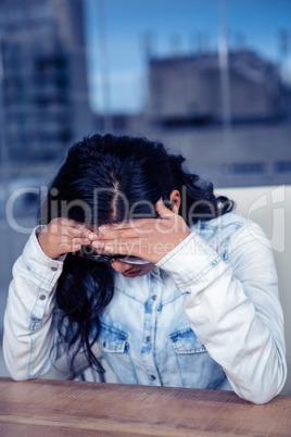 Troubled Asian woman with hands on face