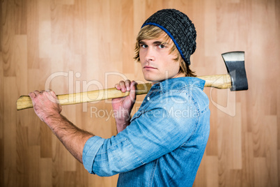 Profile of hipster standing with axe