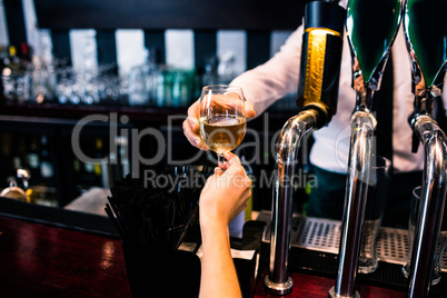 Barman giving drink to customer