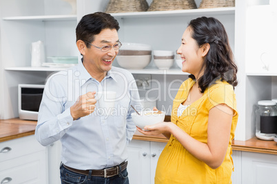 Happy expectant couple in the kitchen